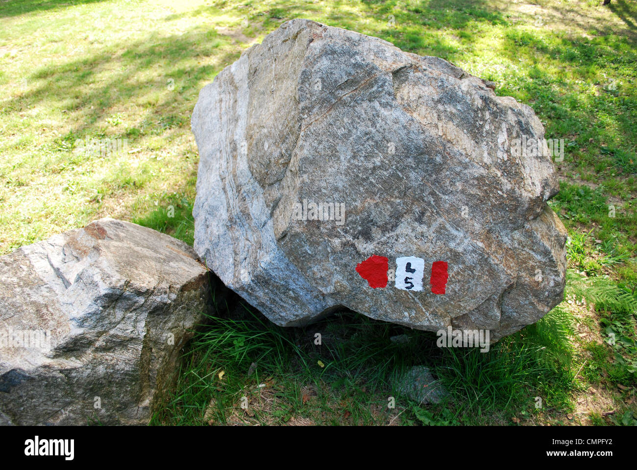 Red and white mountain hiking trail sign painted on a rock Stock Photo