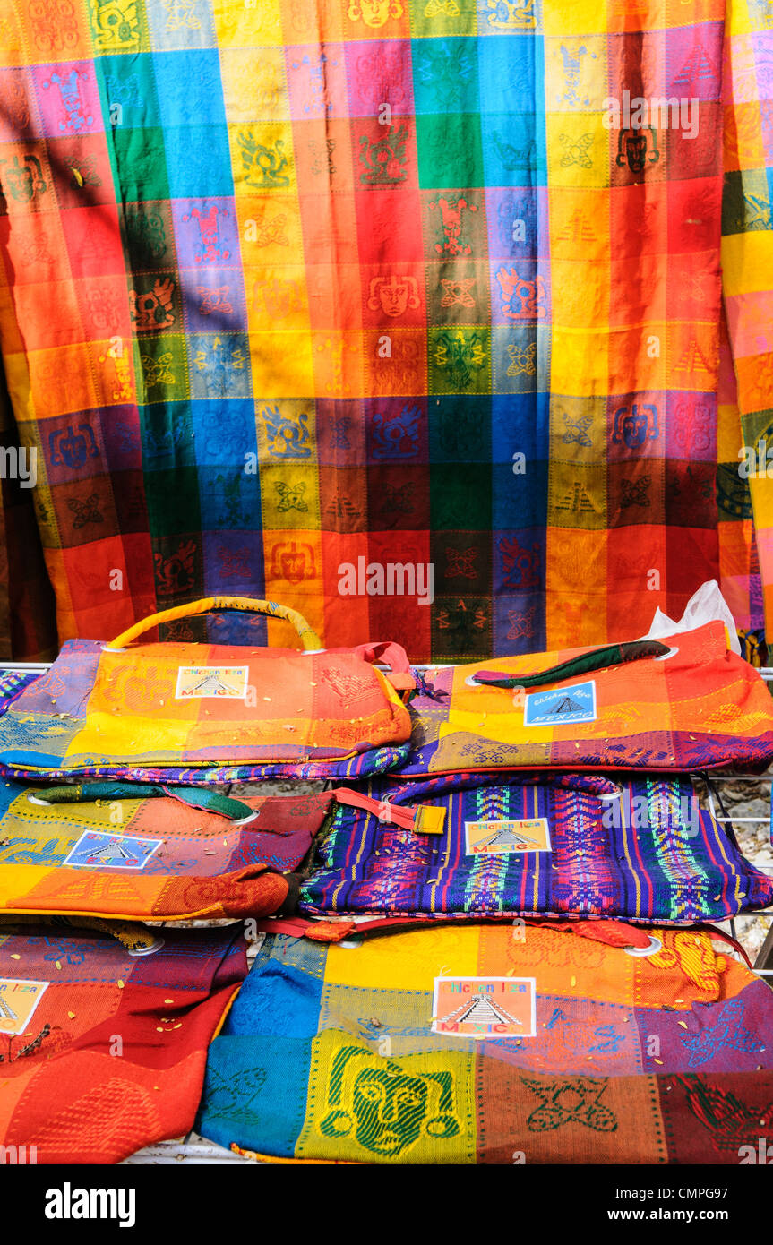 CHICHEN ITZA, Mexico - Brightly colored woven textiles for sale at the market stalls selling local souvenirs and handicrafts to tourists visiting Chichen Itza Mayan ruins archeological site in Mexico. Stock Photo