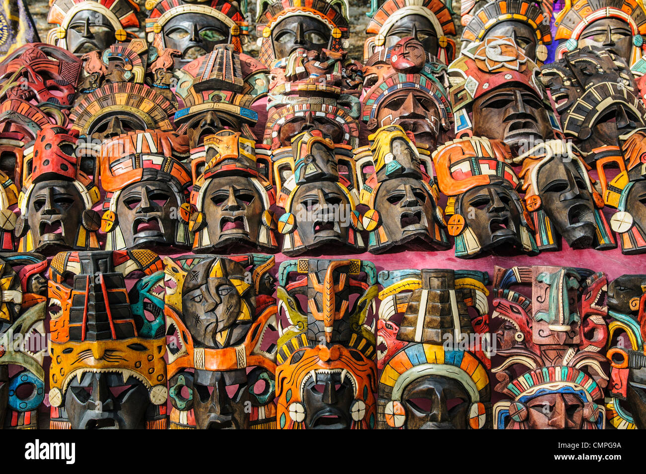 CHICHEN ITZA, Mexico - Market stalls selling wooden masks and other local souvenirs and handicrafts to tourists visiting Chichen Itza Mayan ruins archeological site in Mexico. Stock Photo