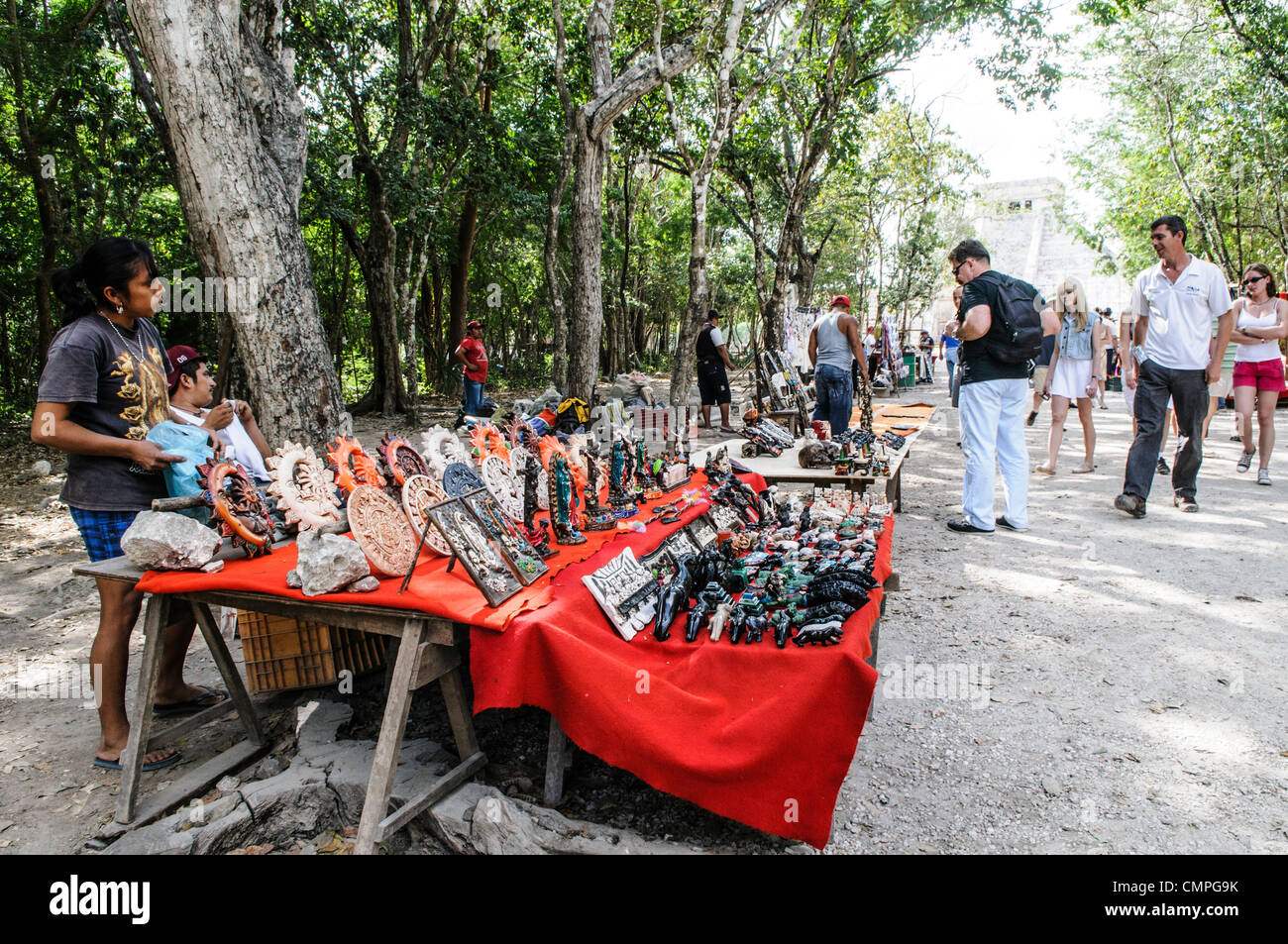 CHICHEN ITZA, Mexico - Tourists shopping at market stalls selling local souvenirs and handicrafts to tourists visiting Chichen Itza Mayan ruins archeological site in Mexico. Stock Photo