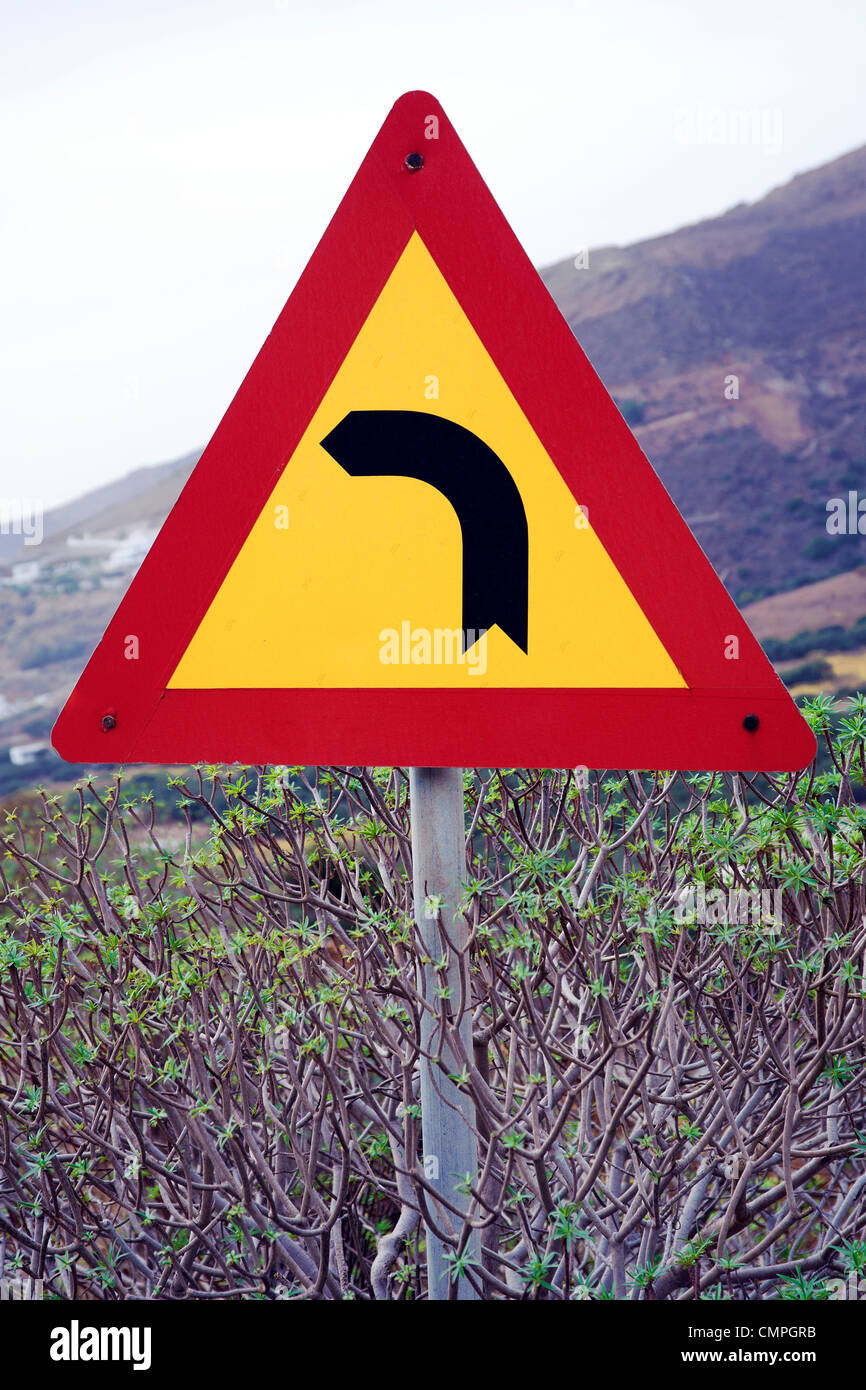 Greek traffic sign indicating a sharp left turn. Stock Photo