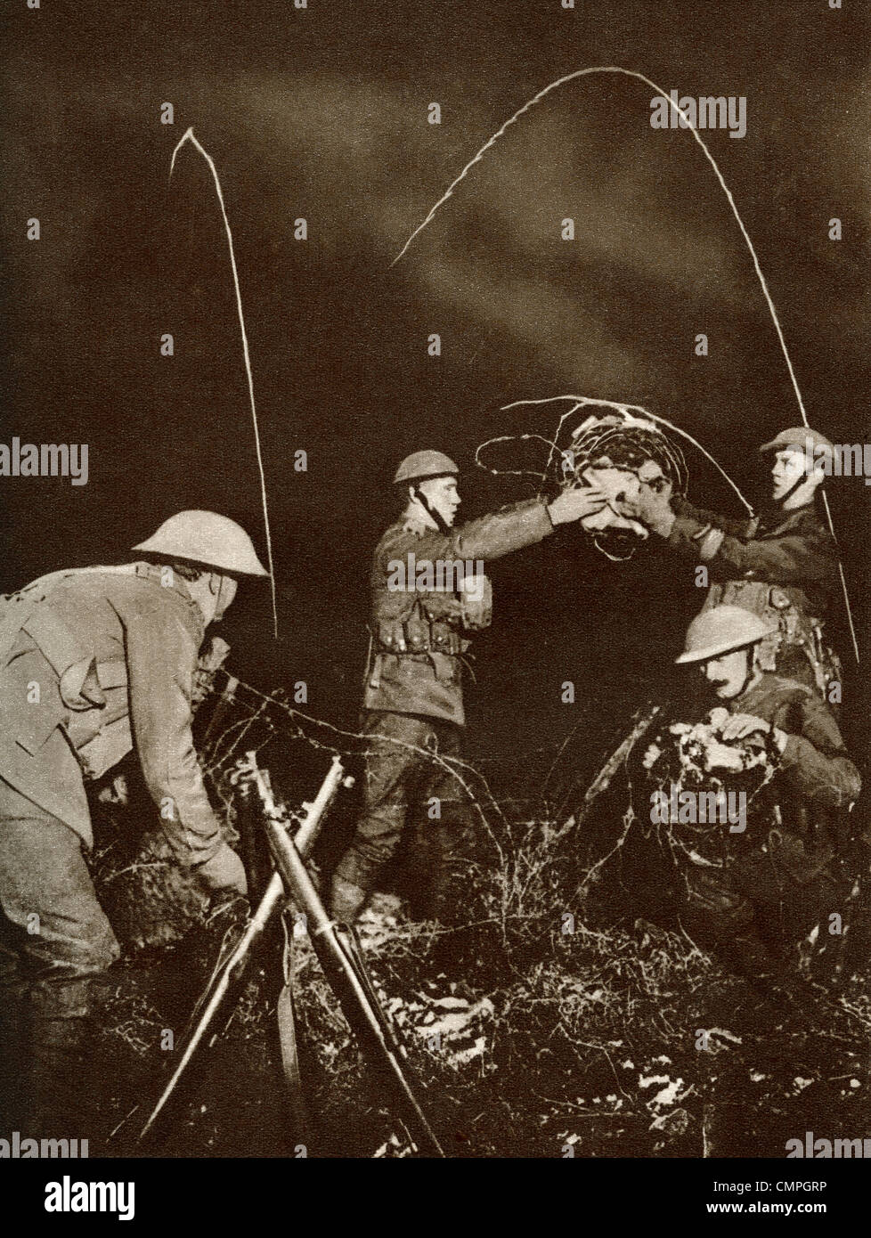 A wiring party. Soldiers erecting barbed wire entanglements in No Man's Land under cover of darkness during World War One. Stock Photo