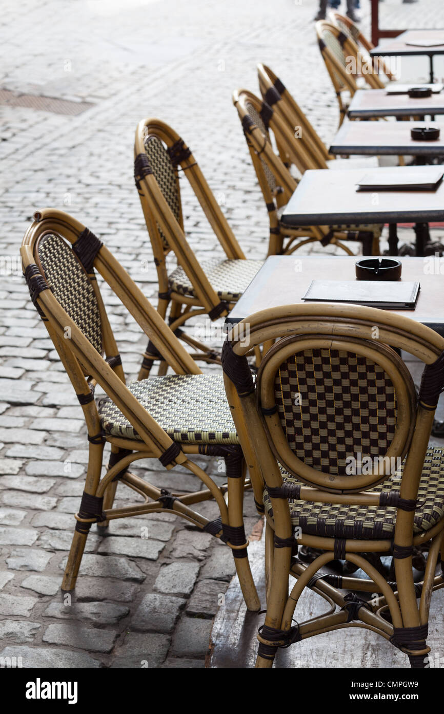 Row of empty restaurant tables and chairs of a street cafe in Belgium Europe close up Stock Photo