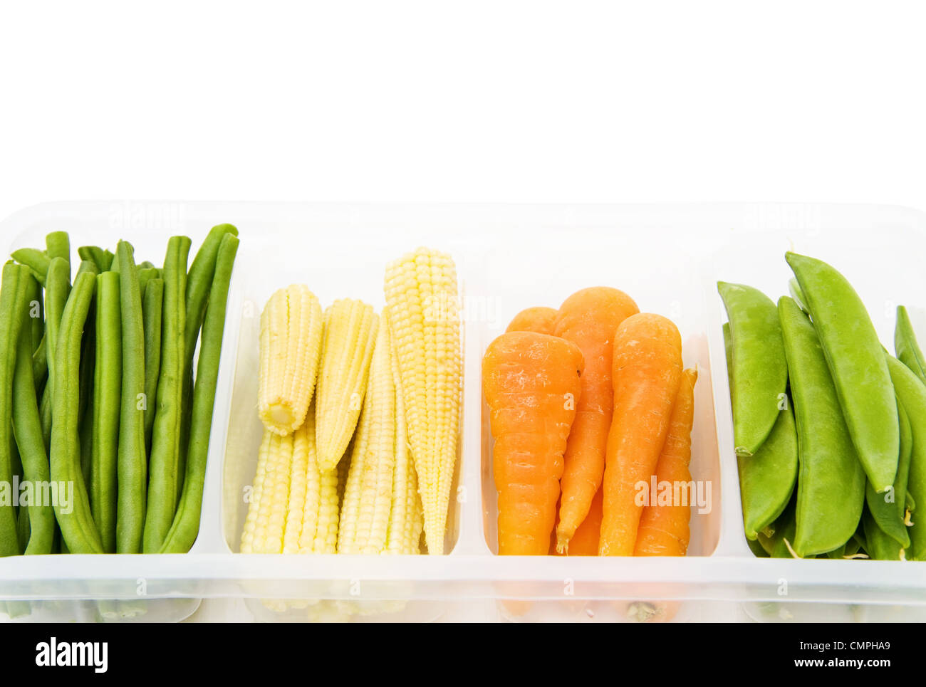 Fresh baby vegetables - carrots, beans, corn, in a casserole. Isolated over white. Stock Photo