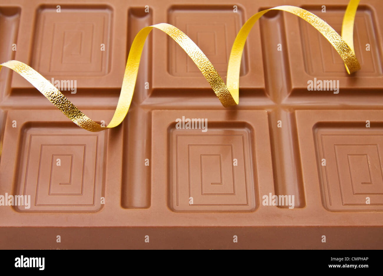 Background of fine Belgian chocolate with festive ribbons for the celebration of a special day. Stock Photo