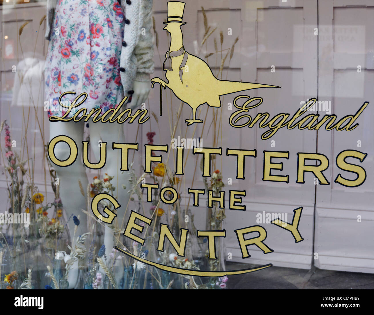 A sign in a shop window that  reads 'Outfitters to the Gentry' Stock Photo