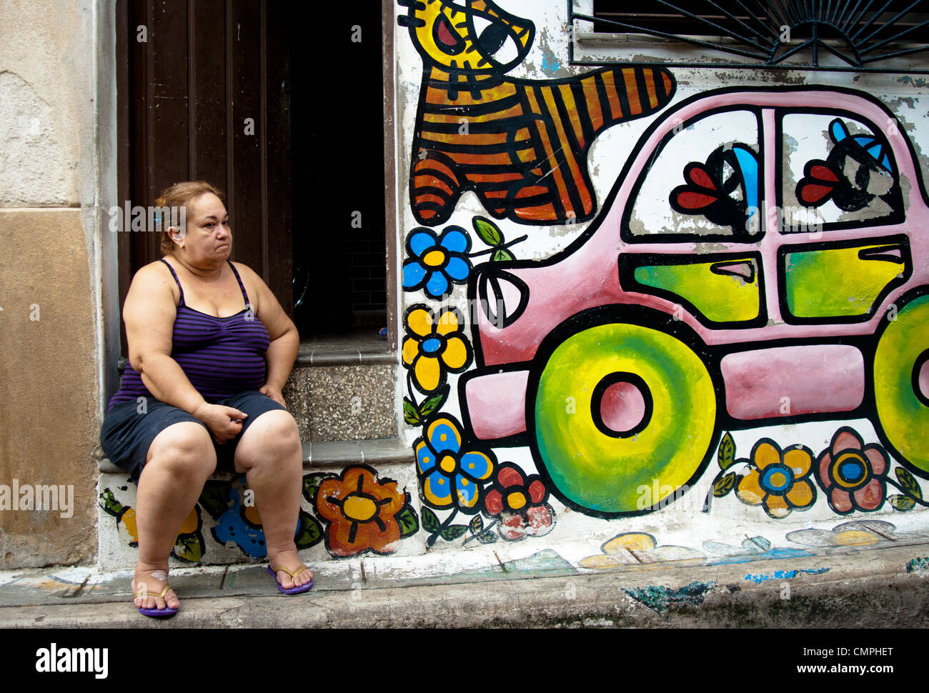 Cuban woman outside her house with colorful graffiti, portrait Stock Photo