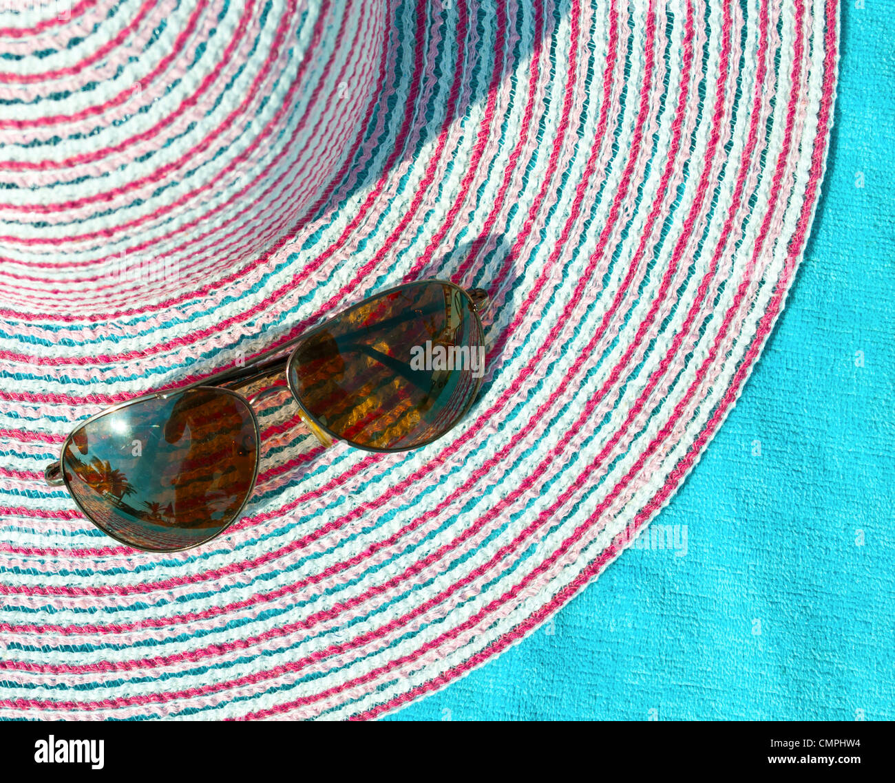 Concept of summer with straw hat and sunglasses on blue towel Stock ...