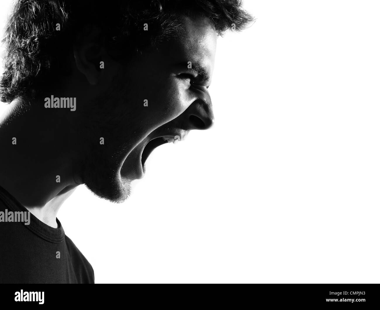 young man screaming angry portrait silhouette in studio isolated on white background Stock Photo
