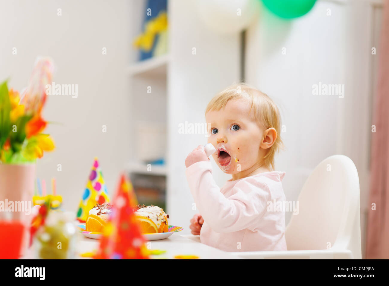 Eat smeared baby eating birthday cake Stock Photo