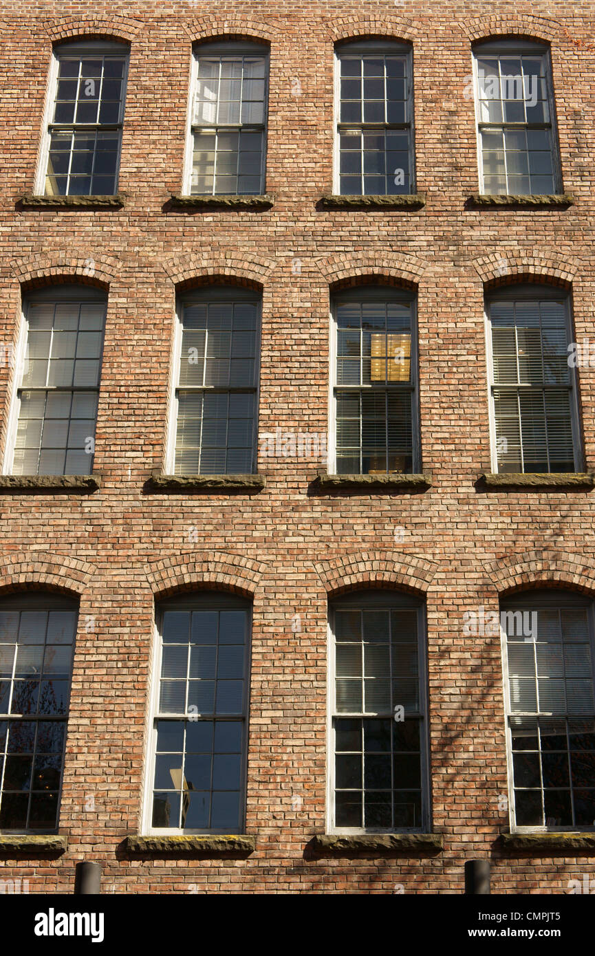 Windows and brick facade of a historical building in Yaletown, Vancouver, British Columbia, Canada Stock Photo