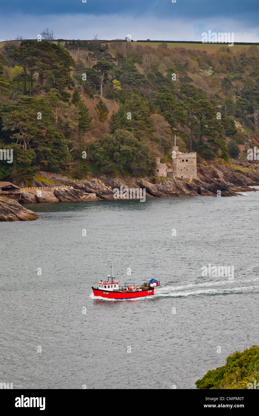 A small fishing boat passes Kingswear Castle guarding the entrance to the River Dart, Devon, England, UK Stock Photo