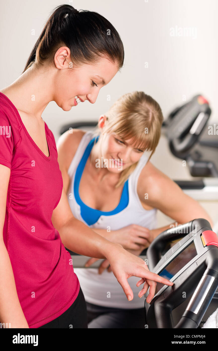 Young women exercising at fitness center on treadmill machine Stock Photo