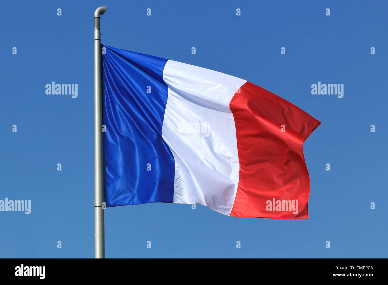 Blue, white and red french flag floating in the wind in a deep blue sky ...