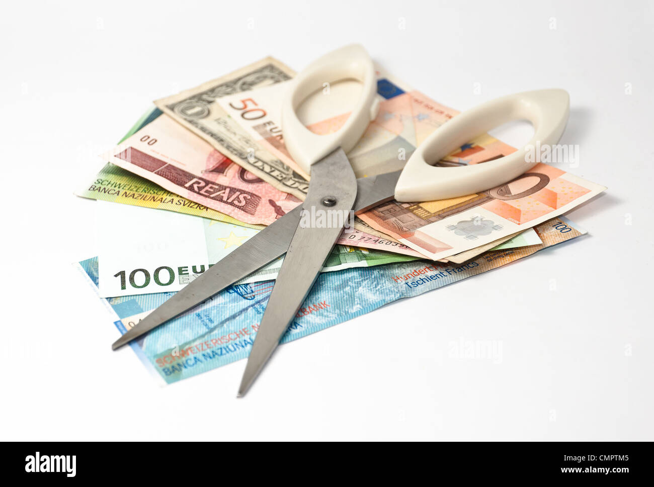 Scissors and several banknotes: cutting the expenses Stock Photo