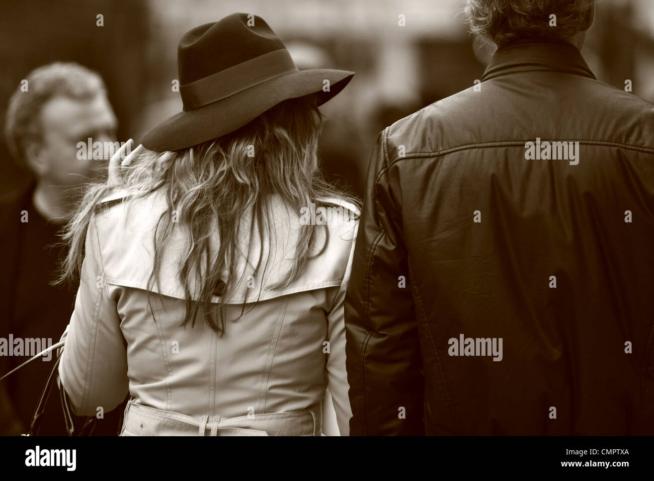 rear view of two people walking along a high street in London Stock ...