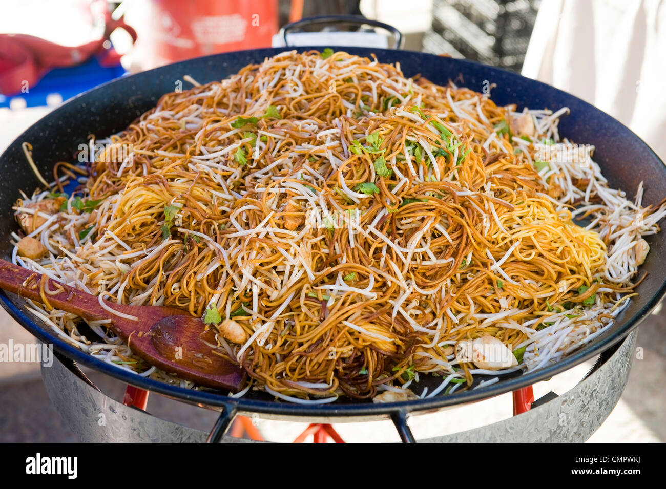 noodles being cooked in a large wok Stock Photo