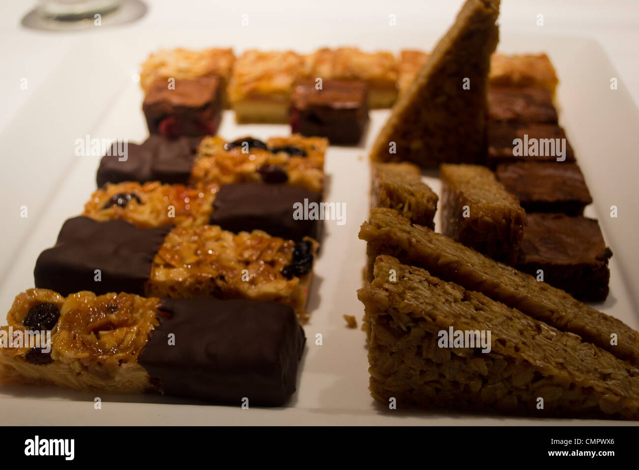 A plate of home-made flapjacks and other treats. Stock Photo