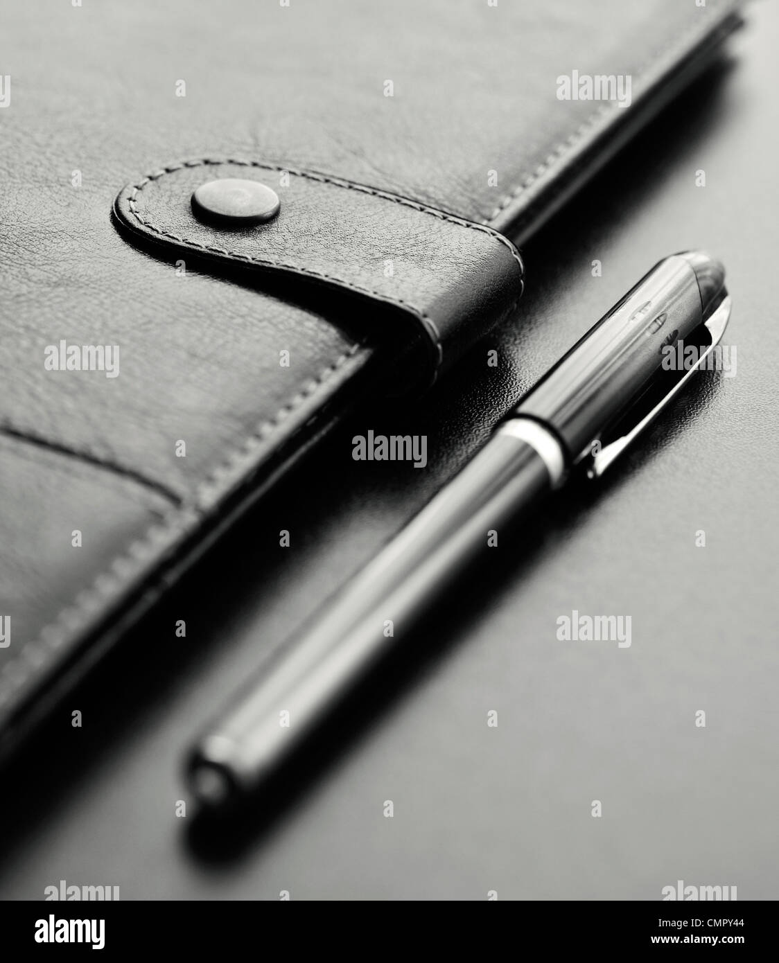 Close-up of a black personal agenda and with a pen with selective focus Stock Photo