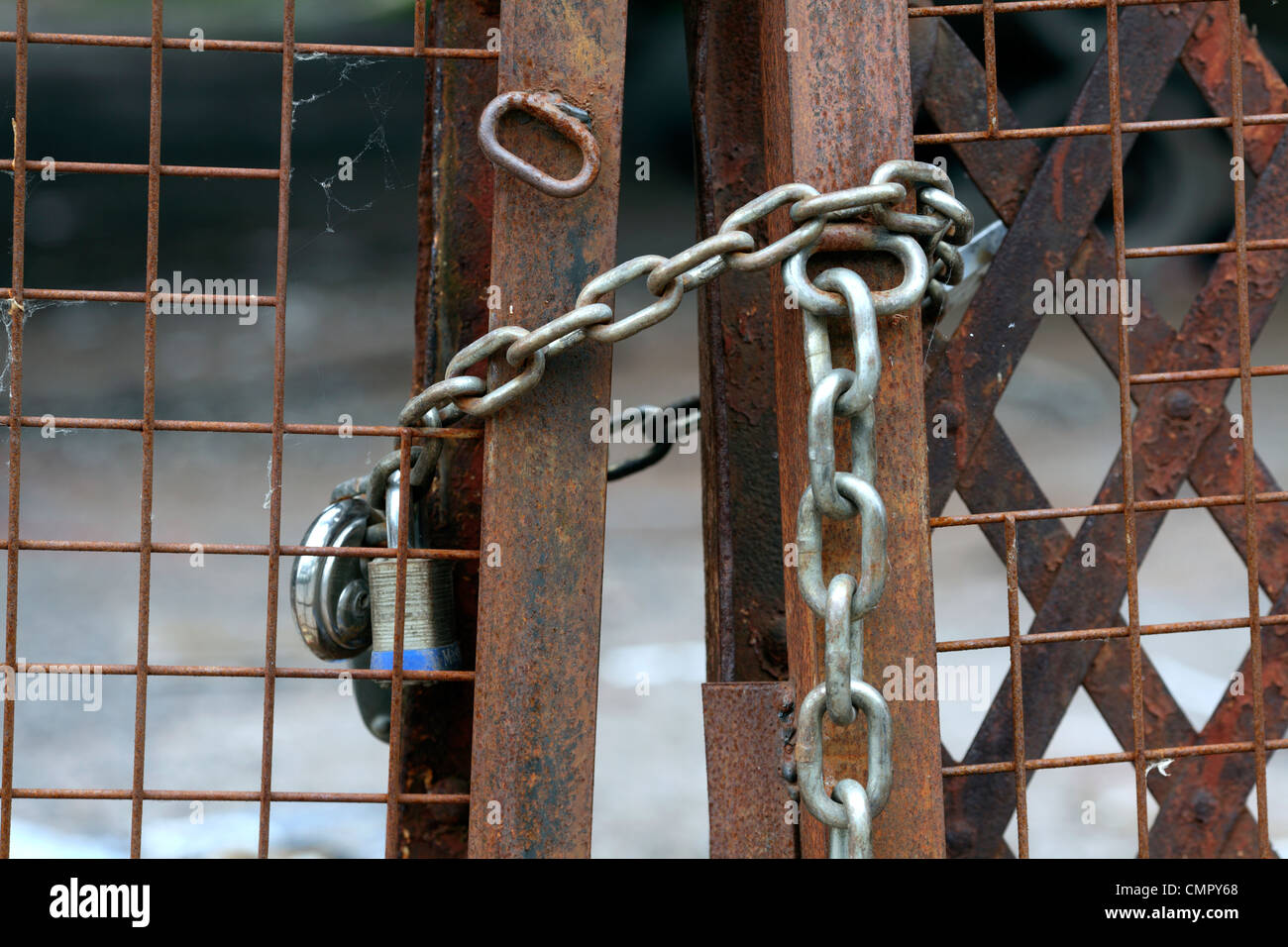 padlocks secure gates at a closed industrial site, Bristol. Stock Photo