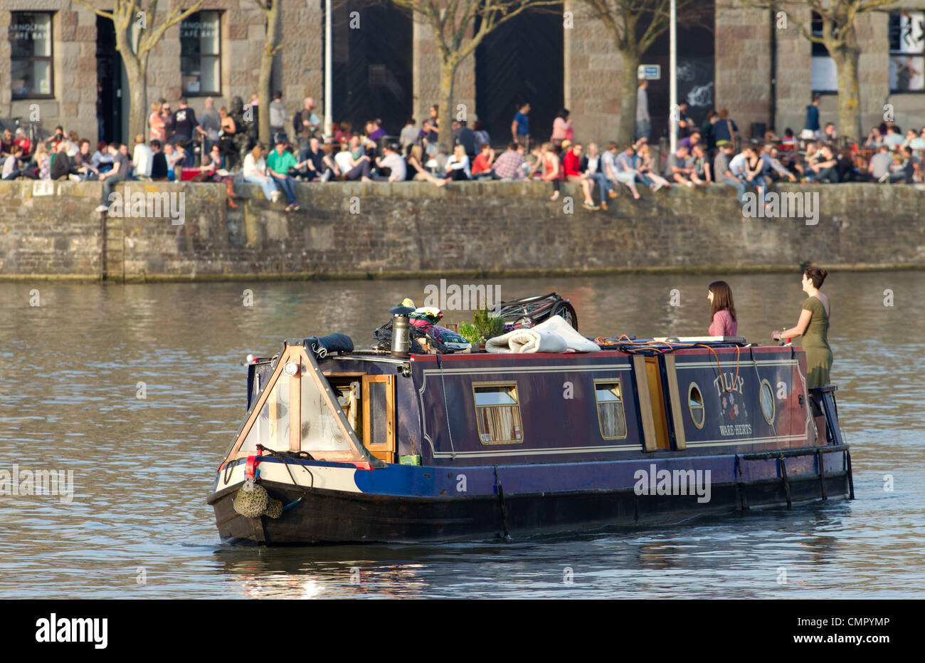 A houseboat travels through the harbourside by the Arnolfini gallery in