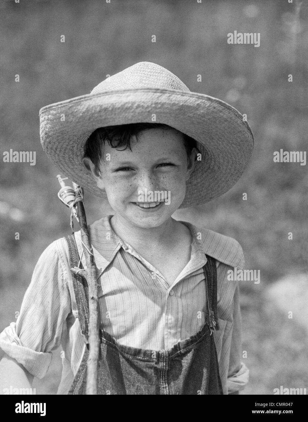1930s SMILING BOY IN OVERALLS & STRAW HAT WITH FISHING POLE SLUNG OVER  SHOULDER Stock Photo - Alamy