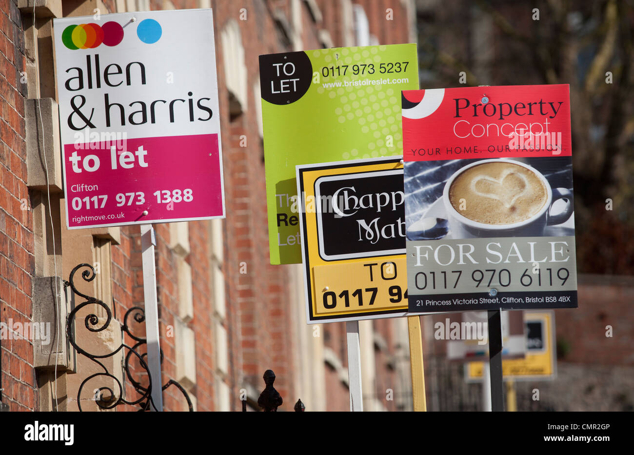 For Sale and To Let signs outside of terraced housing in Bristol on a sunny day. Local estate agents advertising properties. Stock Photo