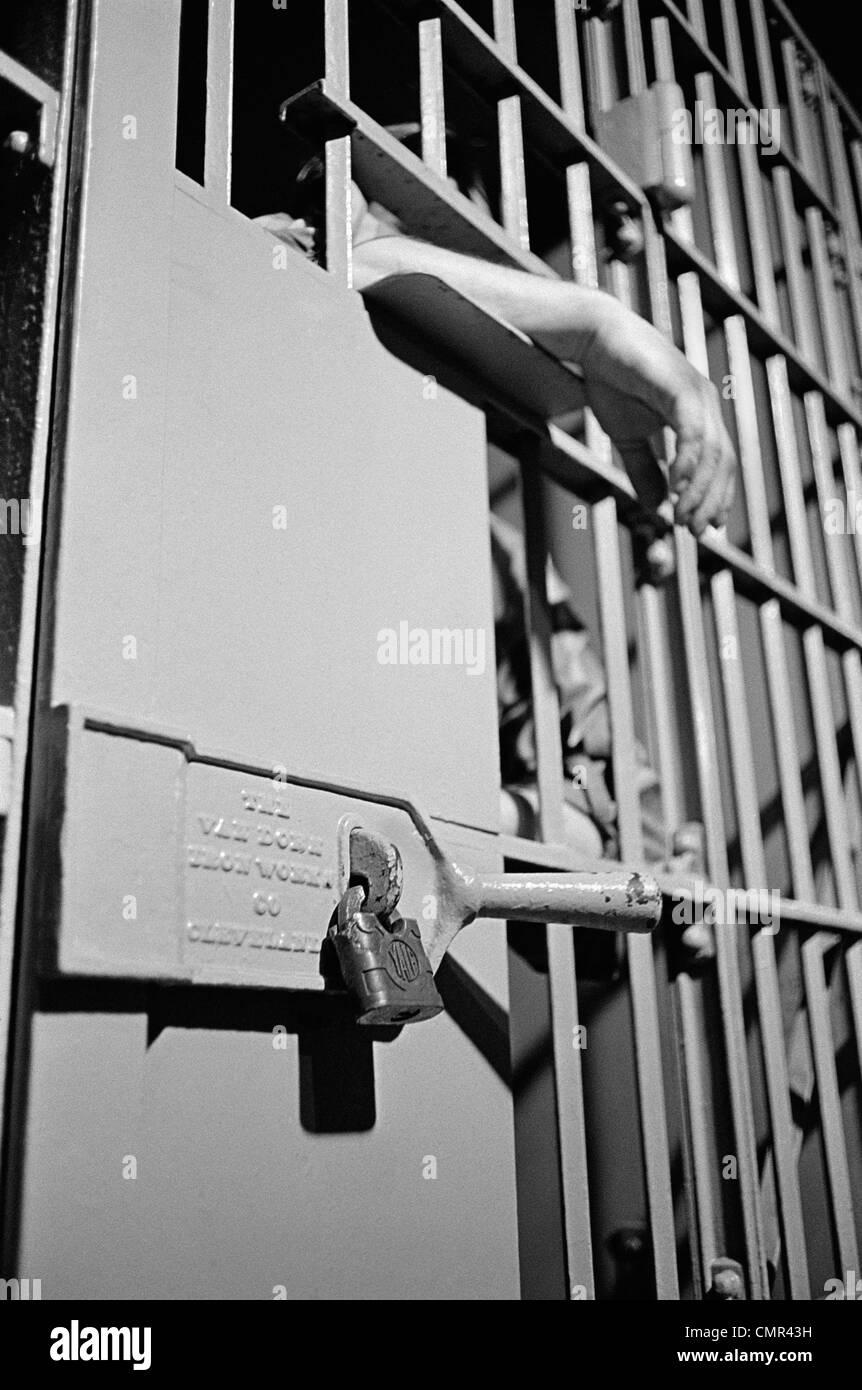 Old prison cell bars hands Black and White Stock Photos & Images Alamy