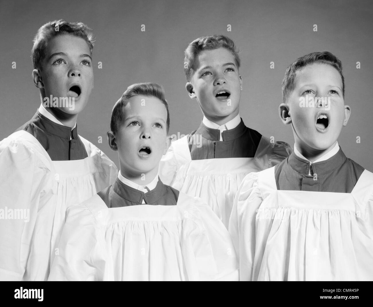 1950S 1960s FOUR CHOIR BOYS SINGING Stock Photo