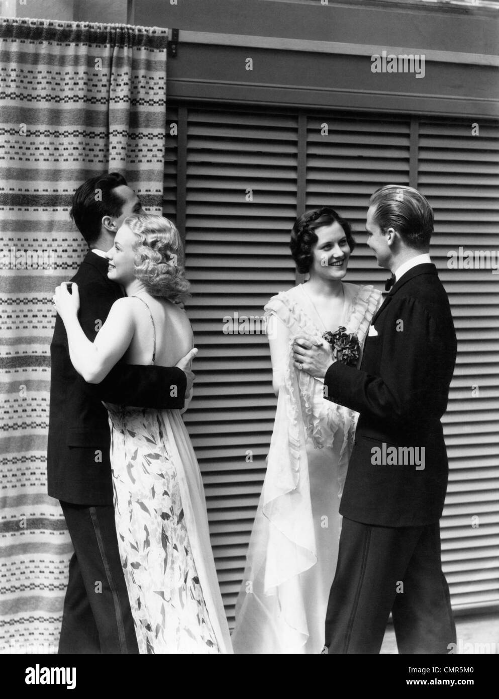 1930s 2 COUPLES MEN WOMEN DANCING WEARING  FORMAL ATTIRE Stock Photo