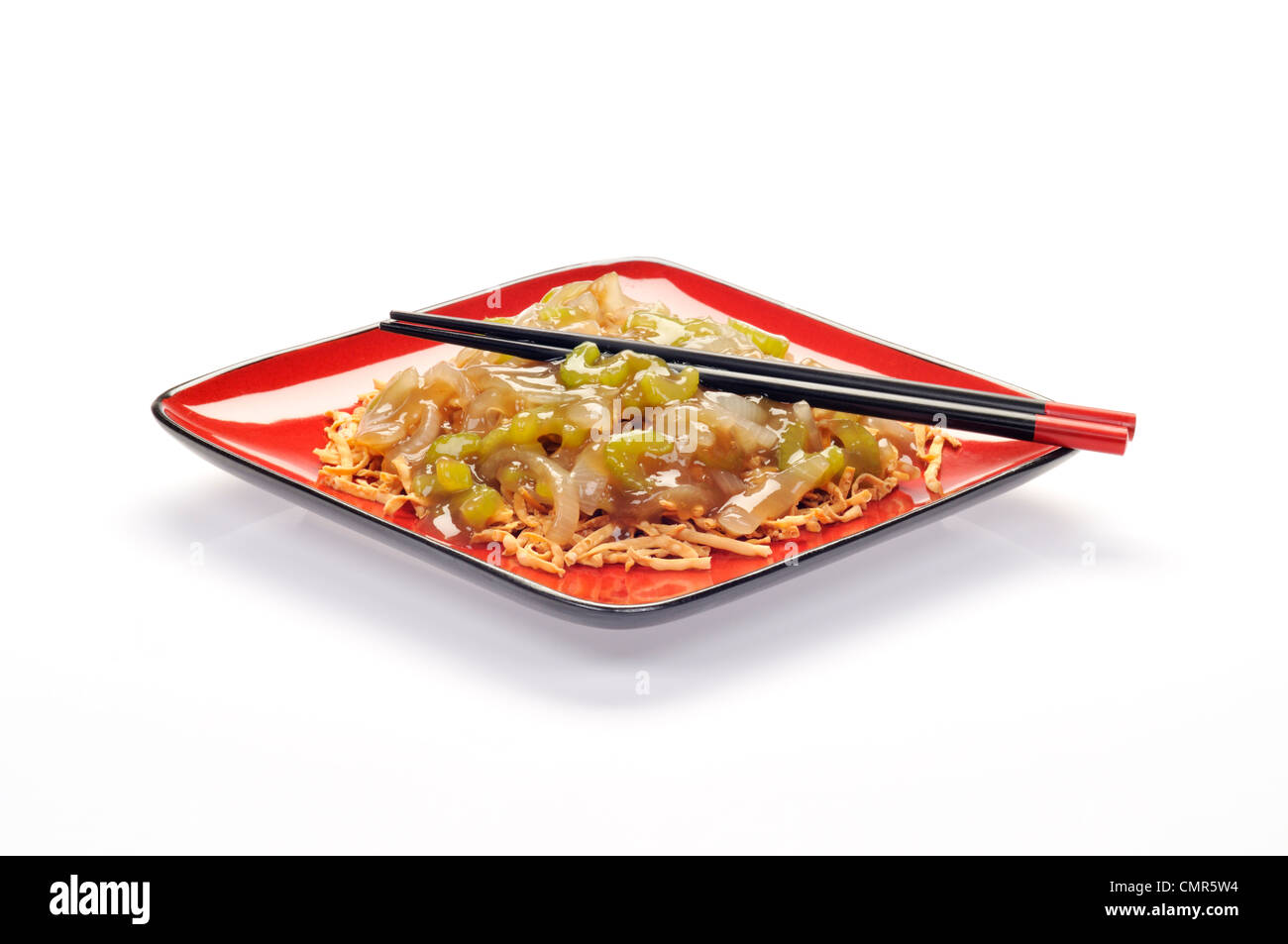 Plate of Chinese vegetable chow mein on red plate with chopsticks Stock Photo