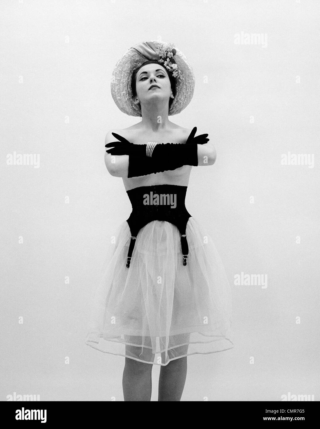 1950s BACK OF TOPLESS WOMAN WEARING HAT AND FULL LENGTH GLOVES PEARL  BRACELET GIRDLE OVER CRINOLINE SKIRT PARASOL BEHIND BACK Stock Photo - Alamy
