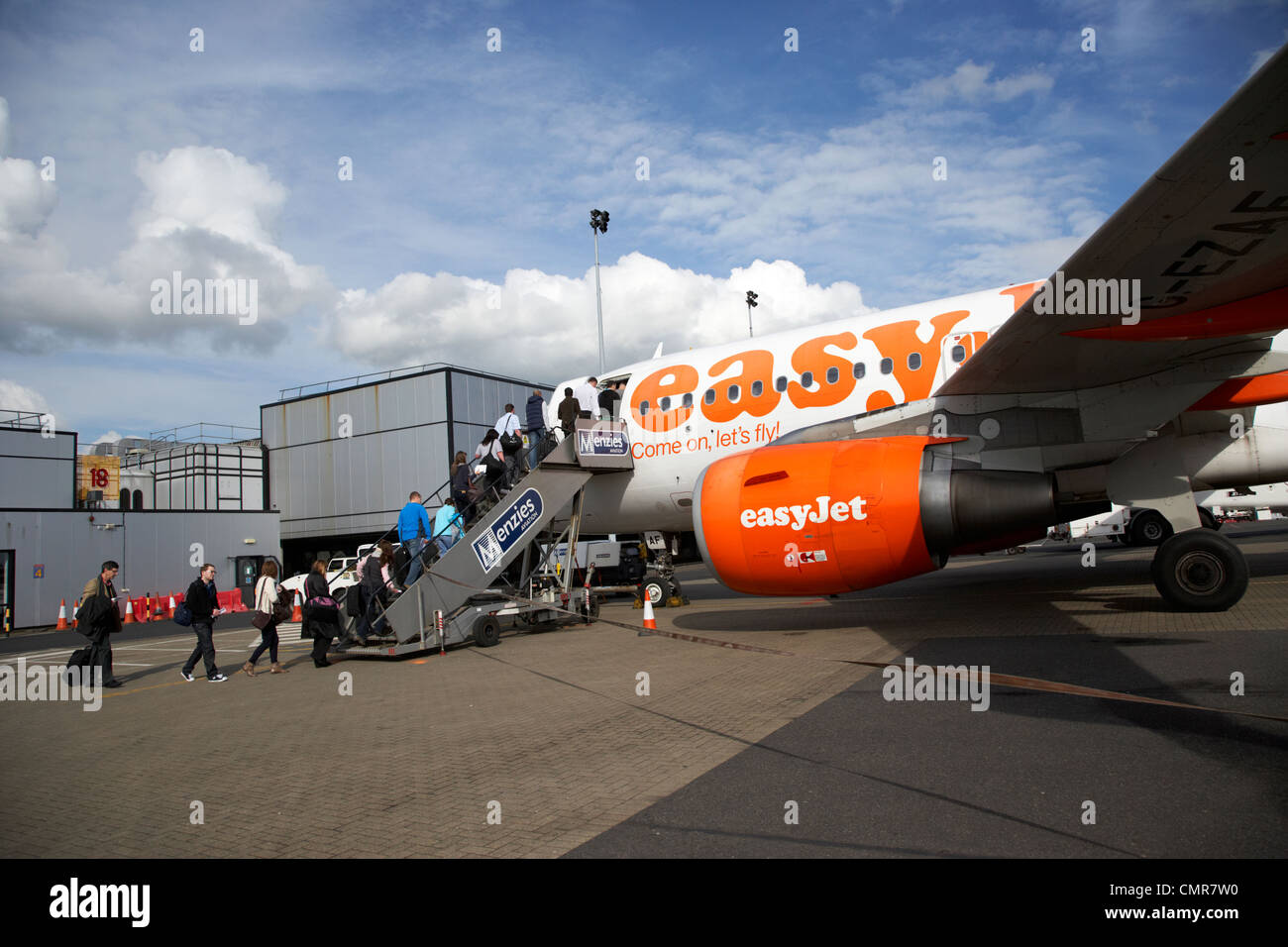 passengers boarding easyjet aircraft at belfast international airport northern ireland uk Stock 