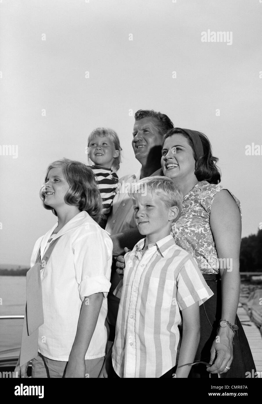 1960s SMILING FAMILY PORTRAIT FATHER MOTHER TWO DAUGHTERS SON STANDING ...
