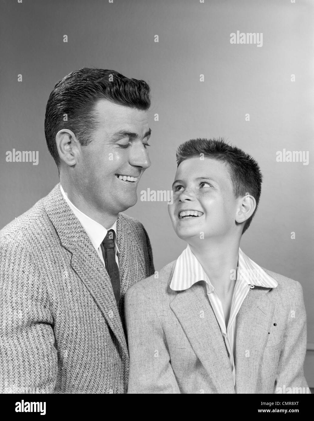 1950s FATHER SMILING AT SON STUDIO PORTRAIT Stock Photo