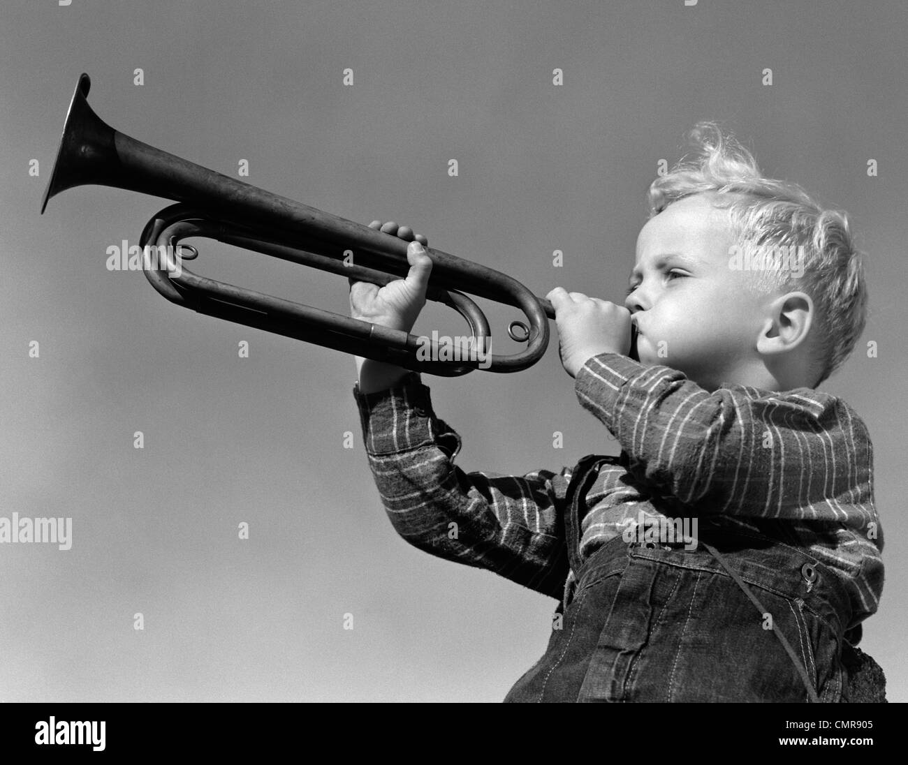 Child blow on trumpet hi-res stock photography and images - Alamy