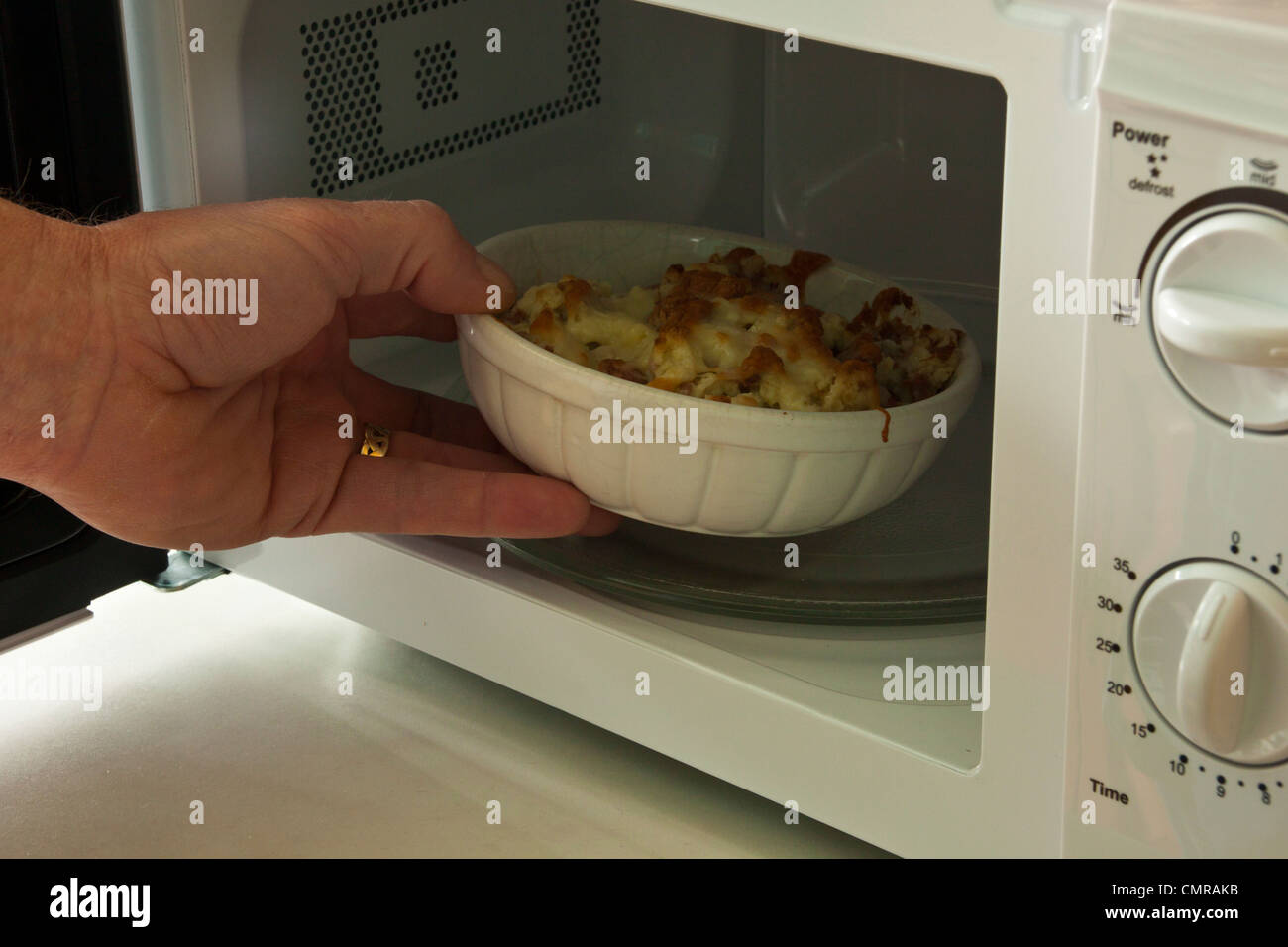 Corned Beef Hash With Cheese In Microwave Oven Stock Photo Alamy