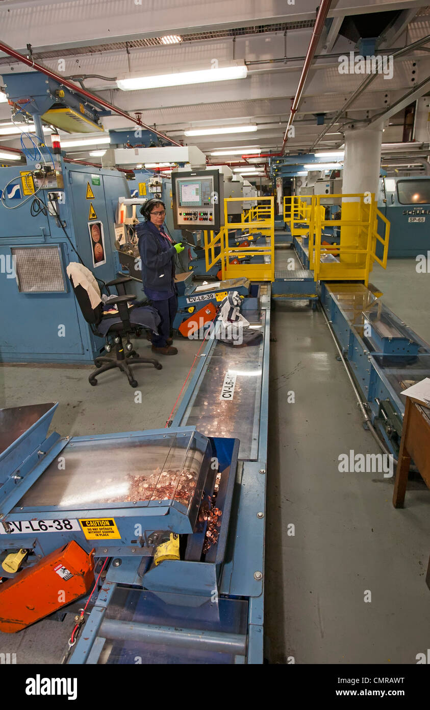 Denver, Colorado - A worker oversees production of penny coins at the United States Mint. Stock Photo