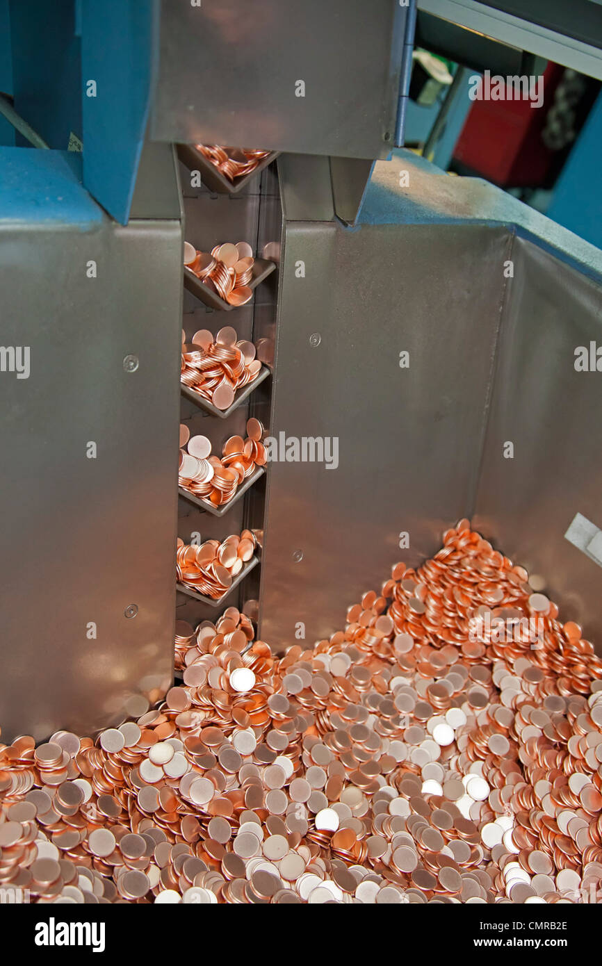 Denver, Colorado - Production of coins at the United States Mint. A machine produces blanks which will be turned into pennies. Stock Photo