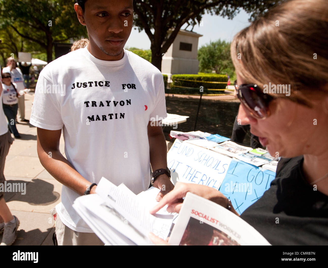 Man hands out literature to woman asking for justice for Trayvon Martin, an unarmed black teen from Florida who was shot dead Stock Photo