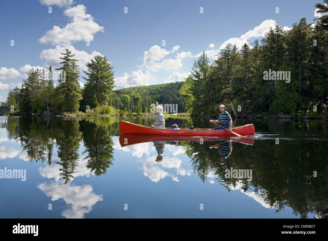 Senior couple canoeing on Smoke Lake, Algonquin Park, Ontario Stock Photo