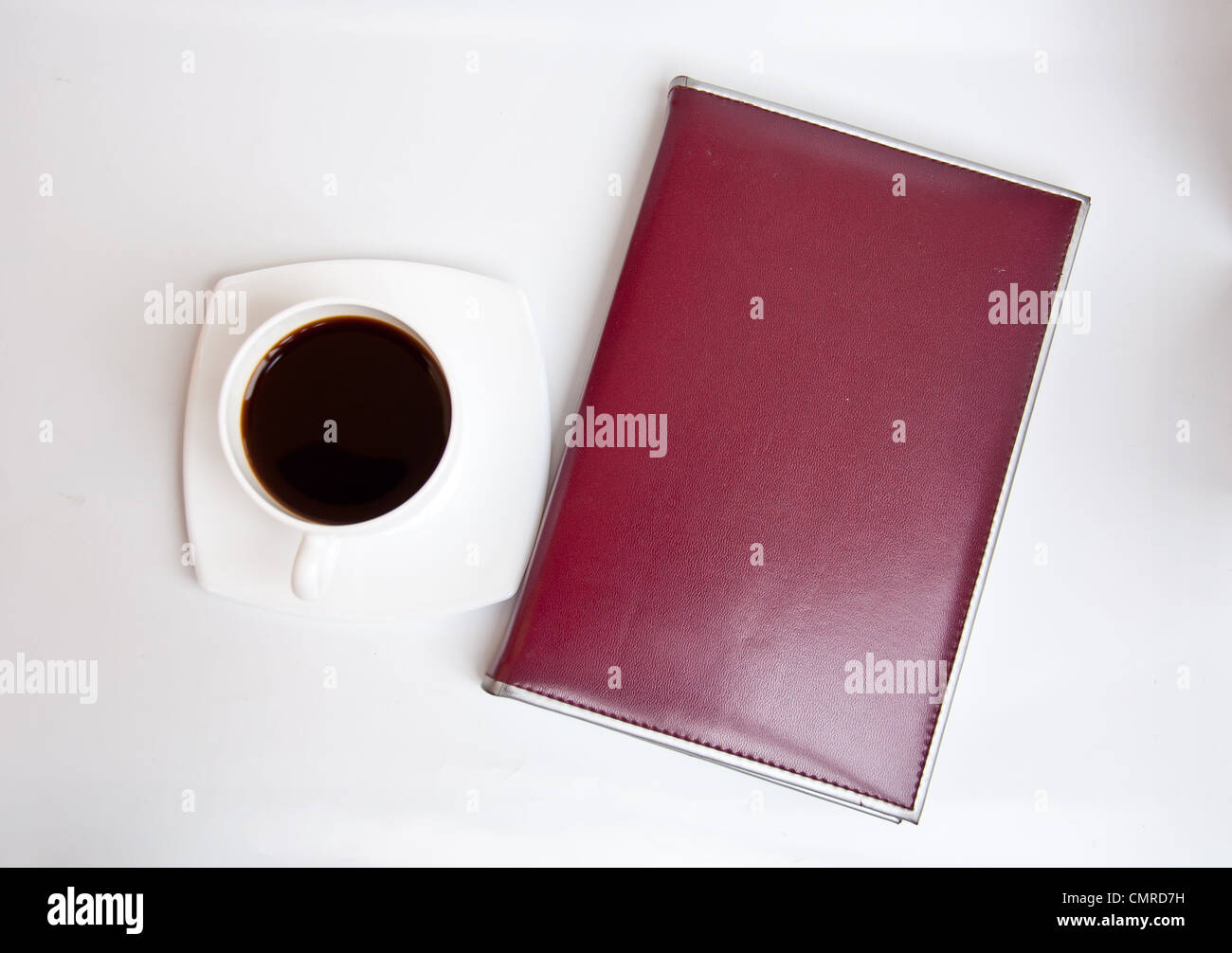 Black coffee and brown notebook on white background Stock Photo