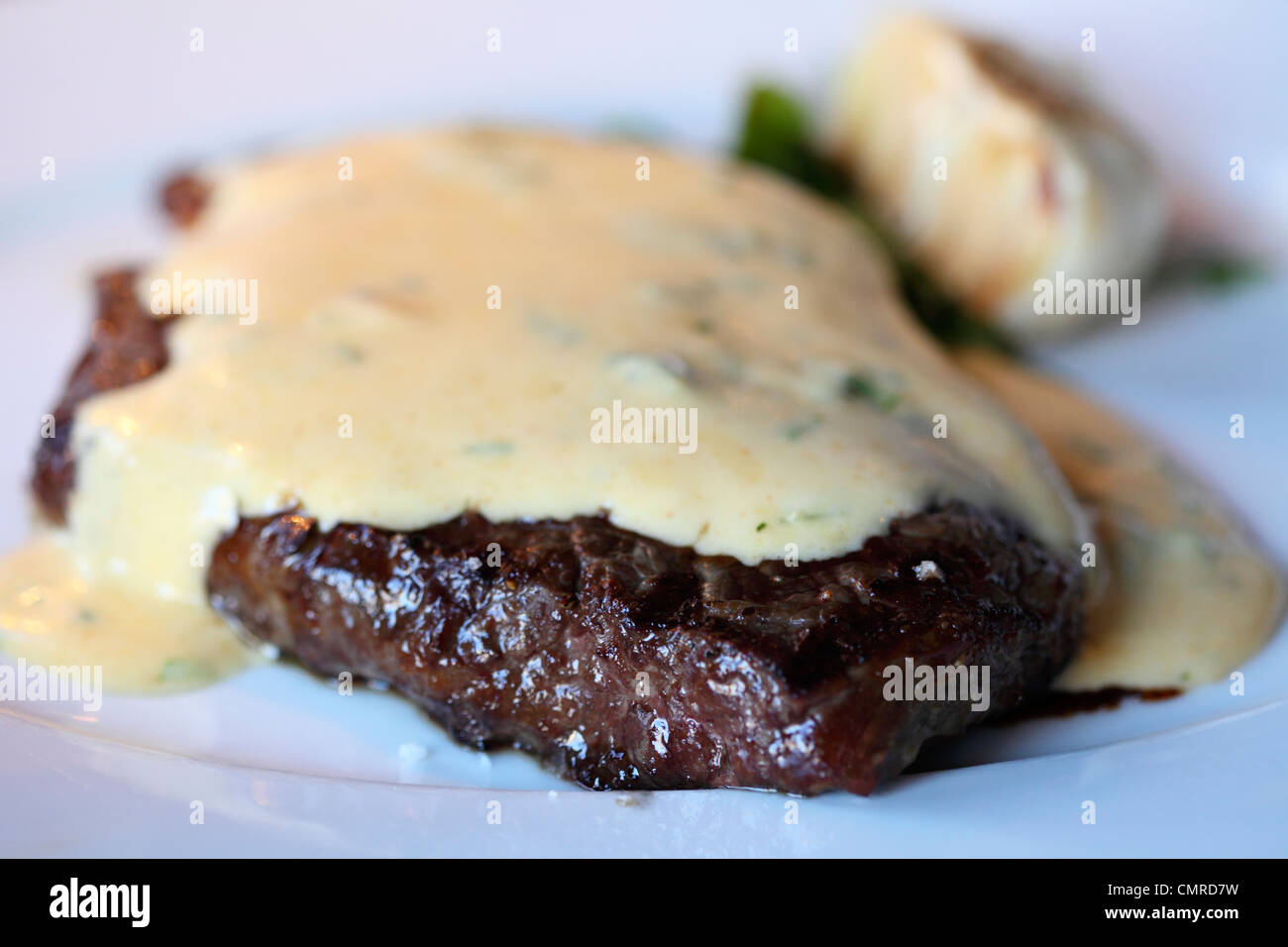 An entrecote of beef is served smothered in Bearnaise Sauce Stock Photo