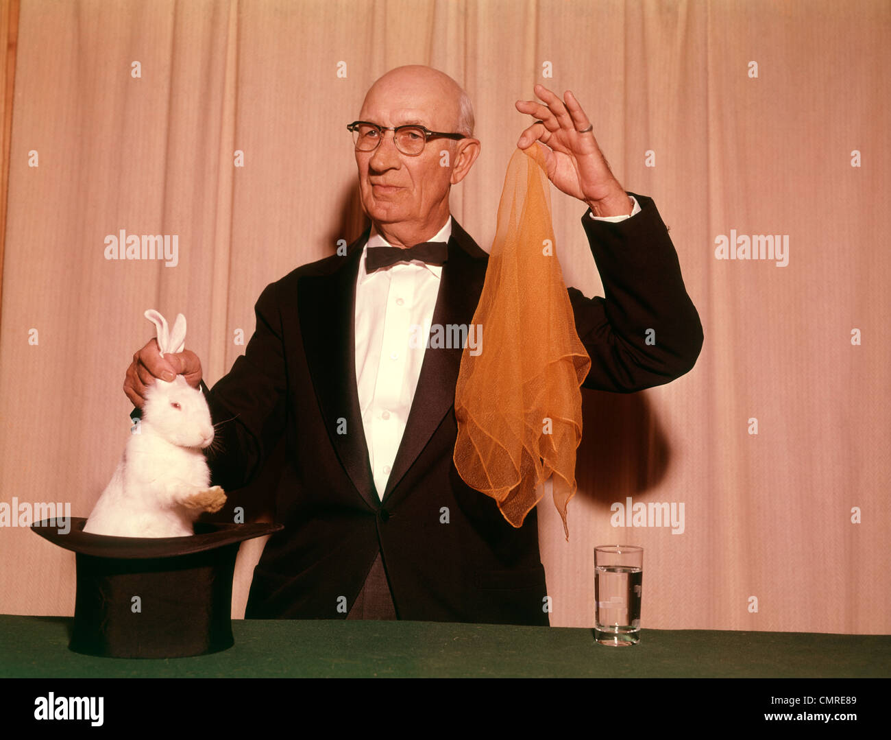 1960s-1970s-magician-pulling-a-white-rab