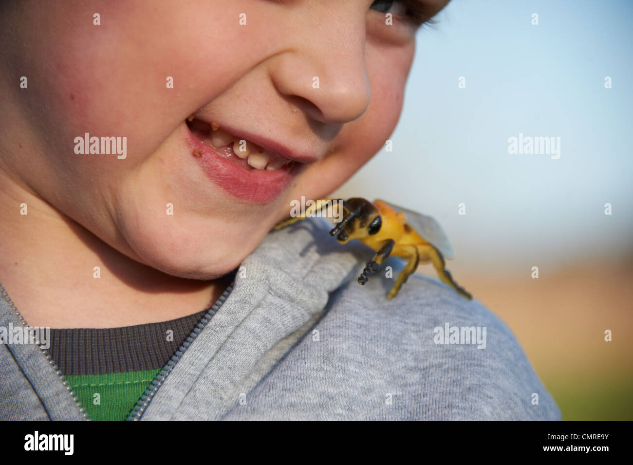 Young Child Boy Playing with Plastic Toy Wasp insect Stock Photo