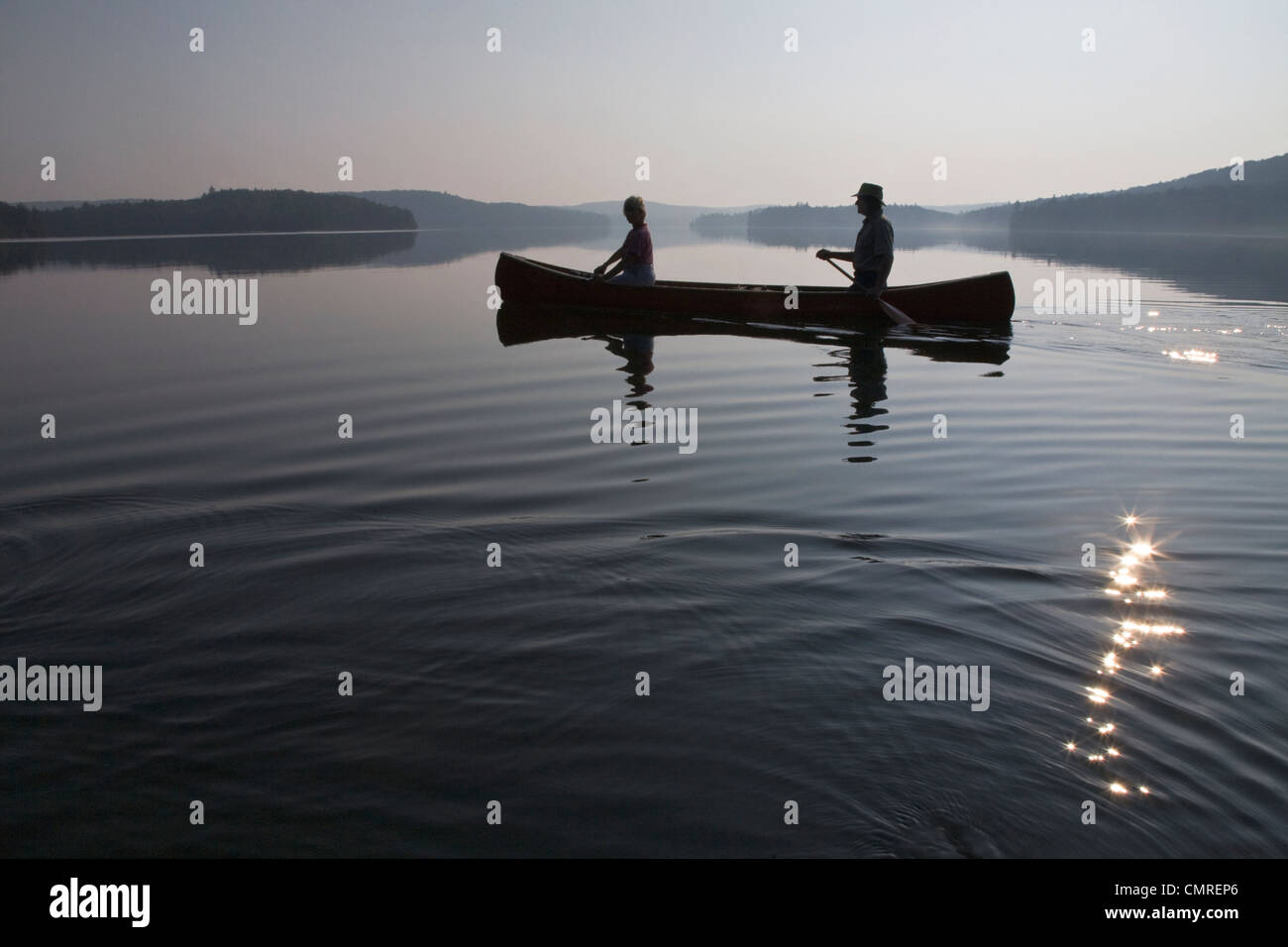 Couple paddling at dawn, Smoke Lake, Algonquin Park, Ontario Stock Photo