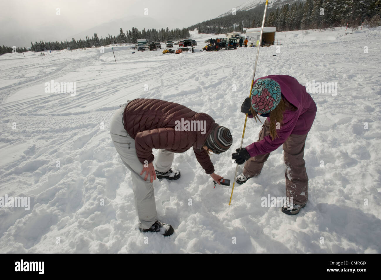 Woman and girl practicing Avalanche search with a Beacon, Avalanche