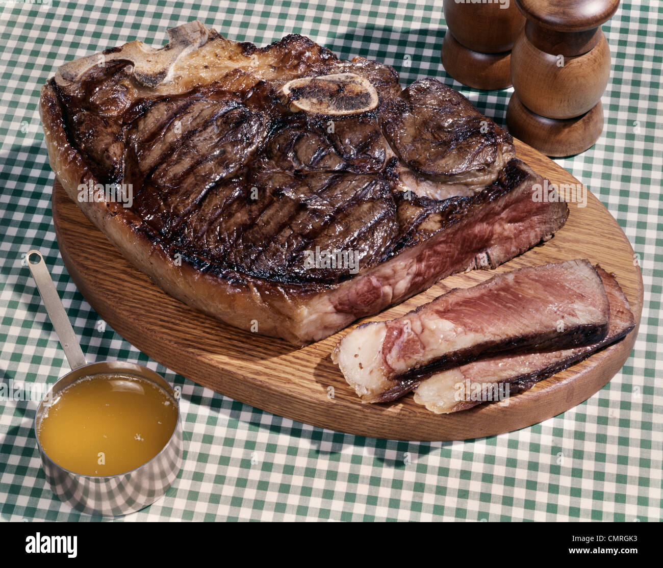 1960s HUGE PORTERHOUSE STEAK ON WOODEN PLATTER SLICED MEDIUM RARE CUP