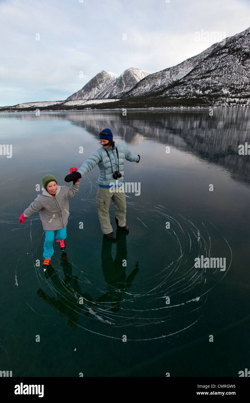 Man spin fishing, fighting a fish, Kusawa Lake, mountains behind, Indian  summer, leaves in fall colours, autumn, Yukon Territory Stock Photo - Alamy