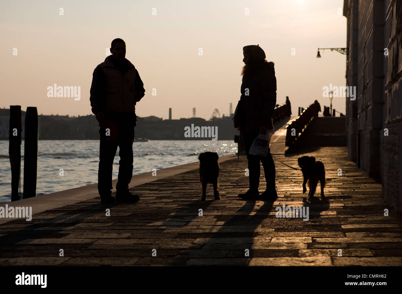 Dog walking Owner taking two dogs for a walk Venice, Italy Stock Photo